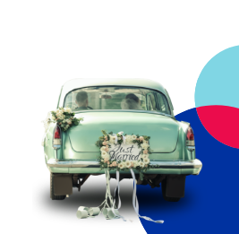 Classic car with marrying partners inside with flowers and just married on the back
